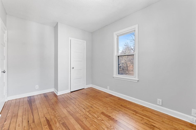 unfurnished room with hardwood / wood-style floors