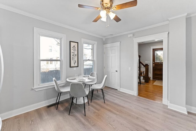 dining room with crown molding, a healthy amount of sunlight, ceiling fan, and light hardwood / wood-style floors