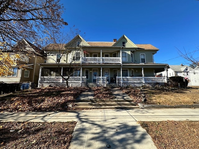 view of front facade featuring covered porch and a balcony