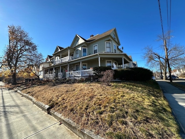 view of side of home featuring covered porch