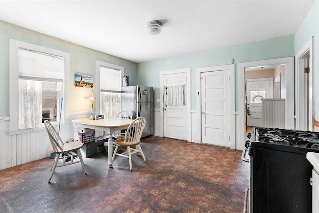 dining area with a wainscoted wall