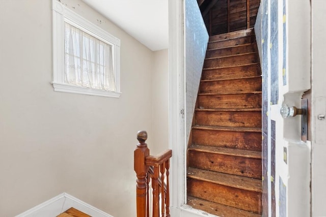 stairway featuring baseboards