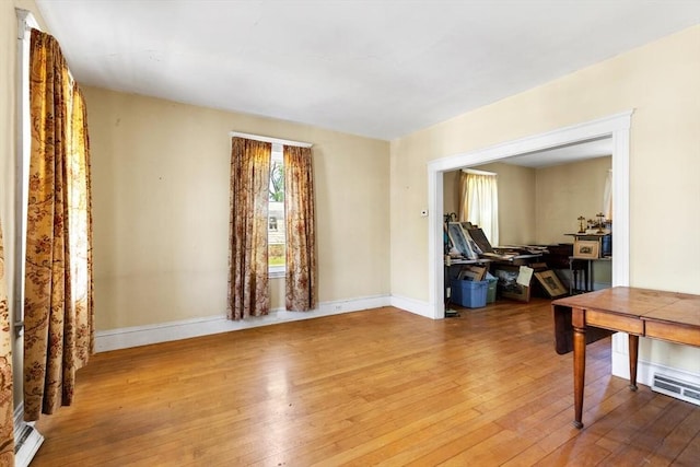 interior space featuring baseboards and hardwood / wood-style floors