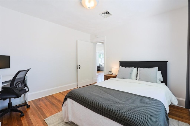 bedroom with wood finished floors and baseboards