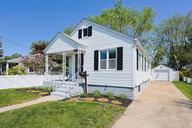 bungalow-style home with an outdoor structure, concrete driveway, a detached garage, and a porch