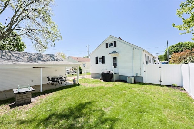 back of house with a gate and a patio area