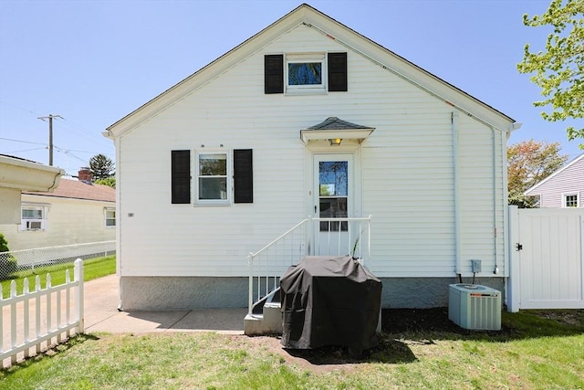 back of house featuring cooling unit