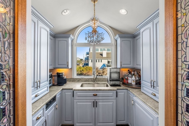 kitchen with gray cabinets, a chandelier, sink, and pendant lighting