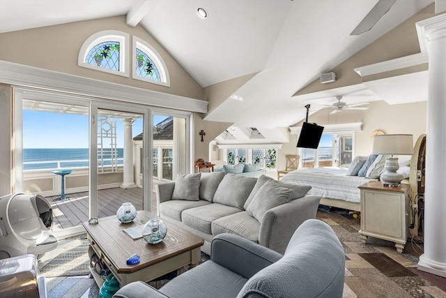 living room with ornate columns, ceiling fan, a water view, beam ceiling, and high vaulted ceiling