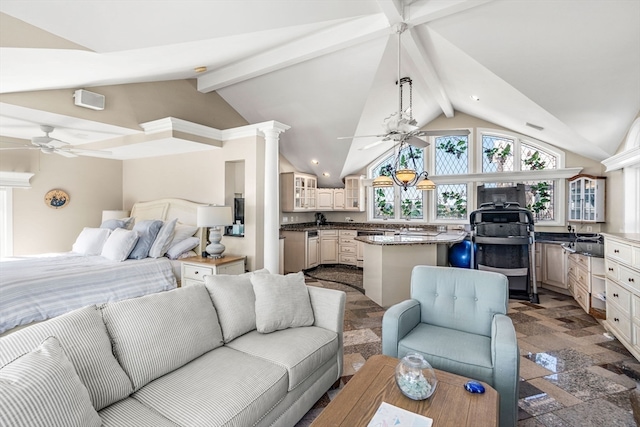 living room featuring ornate columns, ceiling fan, and vaulted ceiling with beams