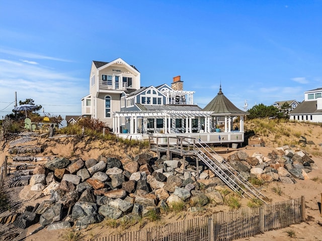 back of property featuring a gazebo