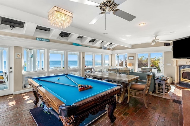 playroom featuring ceiling fan, beamed ceiling, billiards, and a fireplace