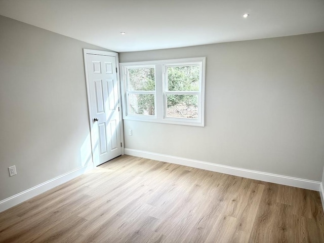 unfurnished room featuring recessed lighting, light wood-type flooring, and baseboards