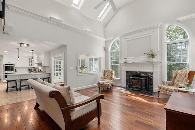 4 Country Way, Hopkinton, MA 01748 - living area with a wood stove, healthy amount of natural light, ceiling fan, hardwood / wood-style floors, and high vaulted ceiling