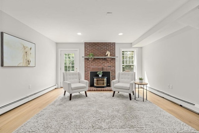 4 Country Way, Hopkinton, MA 01748 - sitting room with wood finished floors, a baseboard heating unit, plenty of natural light, a fireplace, and recessed lighting