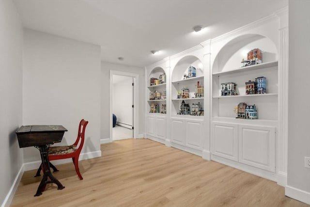 4 Country Way, Hopkinton, MA 01748 - living area with light wood-type flooring, a baseboard radiator, and built in shelves