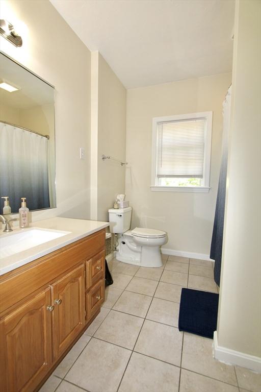 239 Union St, Franklin, MA 02038 - bathroom featuring tile patterned flooring, vanity, toilet, and baseboards