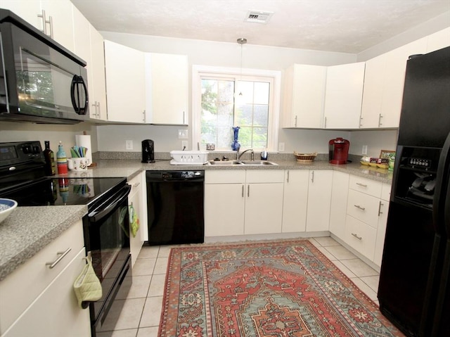 239 Union St, Franklin, MA 02038 - kitchen with black appliances, a sink, light tile patterned floors, and light countertops