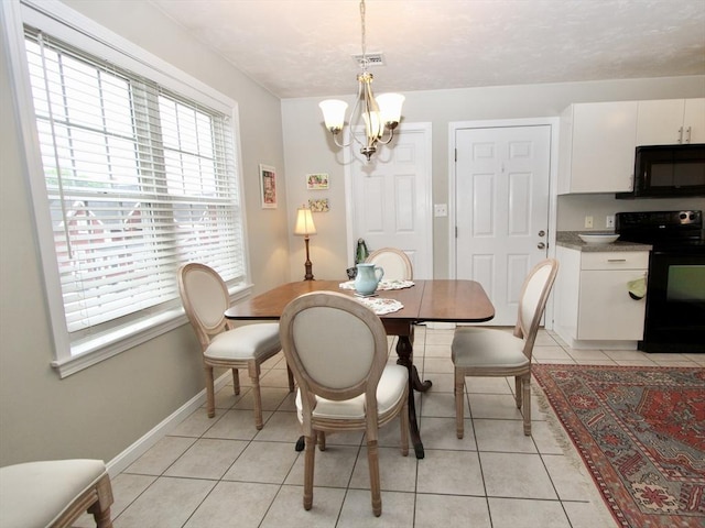 239 Union St, Franklin, MA 02038 - dining room with a chandelier, light tile patterned floors, and baseboards