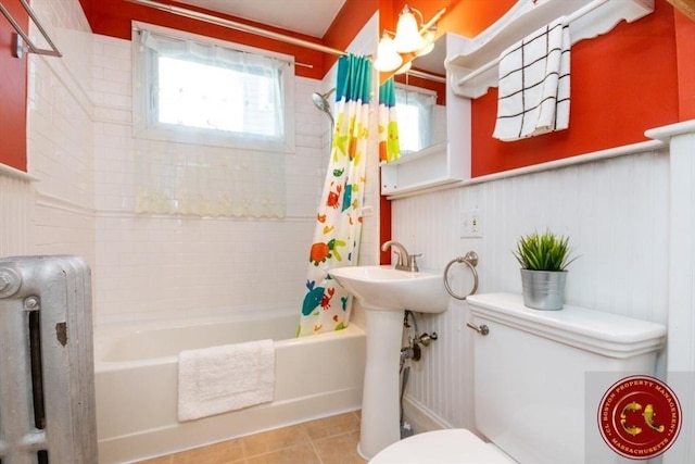 full bathroom featuring tile patterned flooring, shower / bath combination with curtain, and toilet