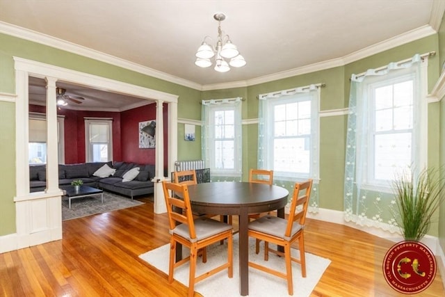 dining room with light wood-style floors, baseboards, and ornamental molding