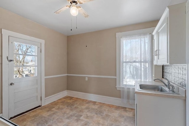 interior space with sink and ceiling fan