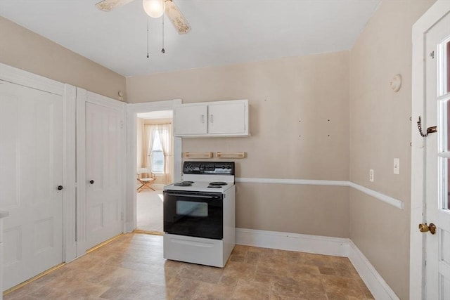 kitchen with electric range oven, white cabinets, and ceiling fan