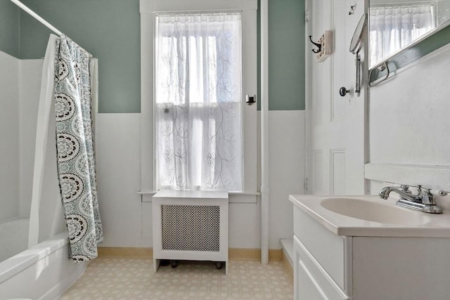 bathroom featuring radiator heating unit, vanity, and shower / bath combo