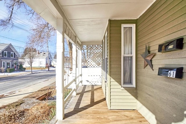 wooden terrace featuring covered porch