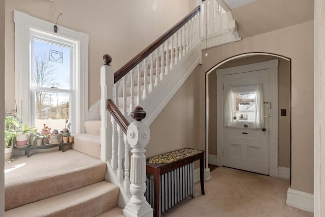 foyer with light colored carpet