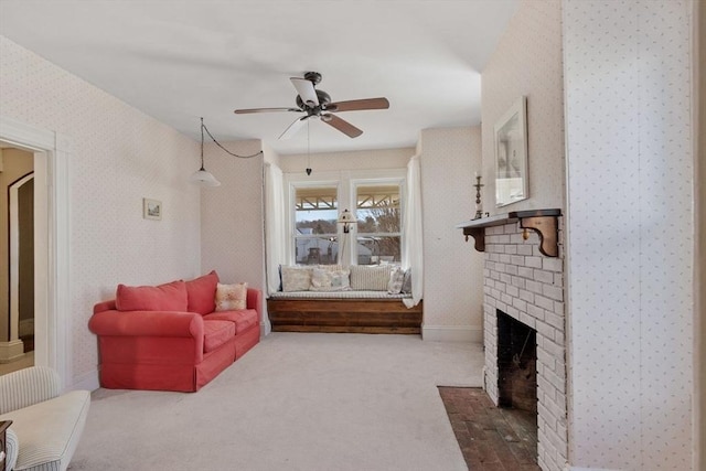 living room featuring a brick fireplace, carpet floors, and ceiling fan