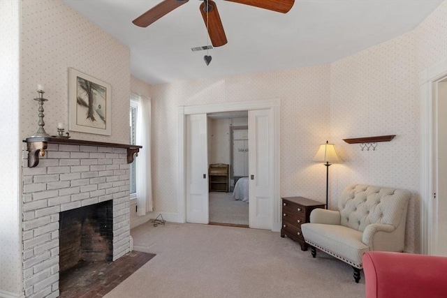 living area with ceiling fan, a fireplace, and carpet floors