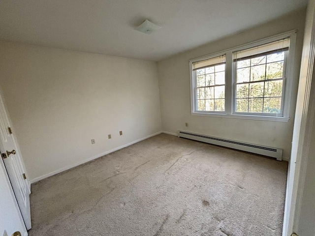 unfurnished room featuring light colored carpet and a baseboard radiator