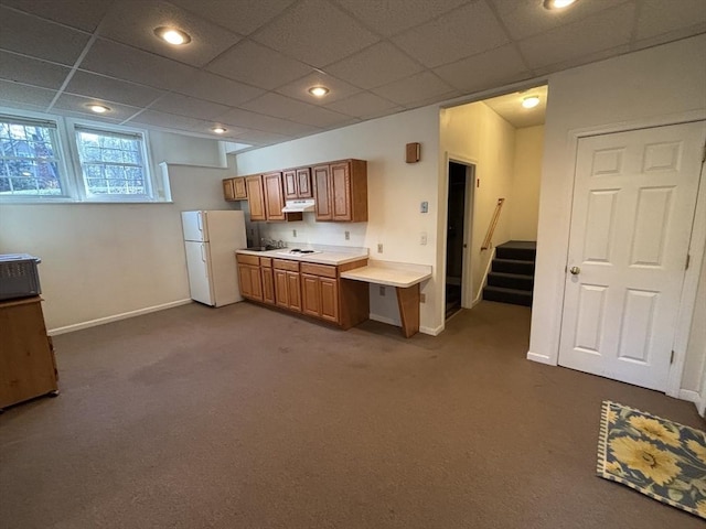 kitchen with a paneled ceiling, carpet floors, and white refrigerator