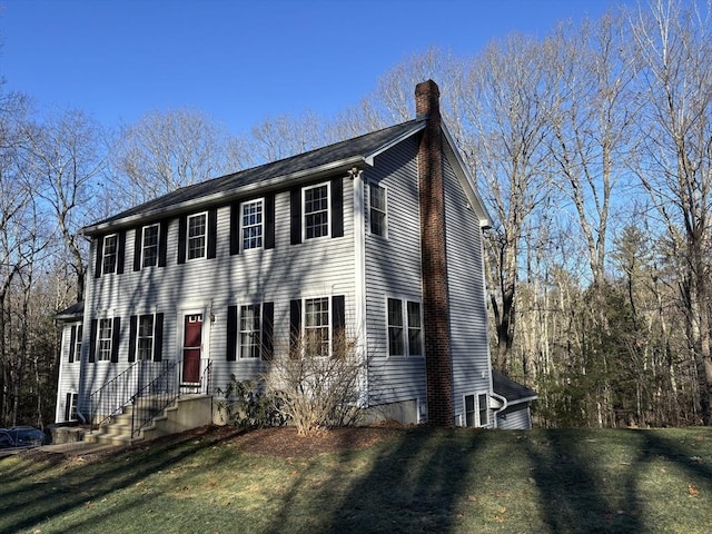 colonial inspired home with a front lawn