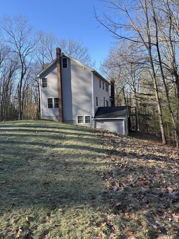 view of side of property with a lawn