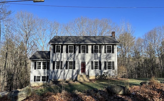 colonial-style house with a front lawn