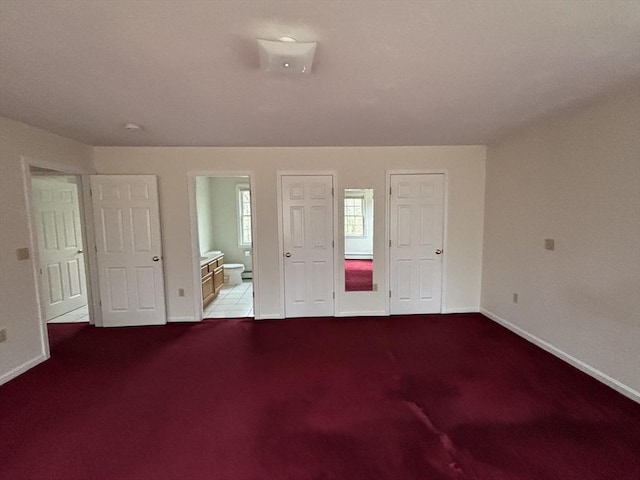 unfurnished bedroom with connected bathroom and light colored carpet