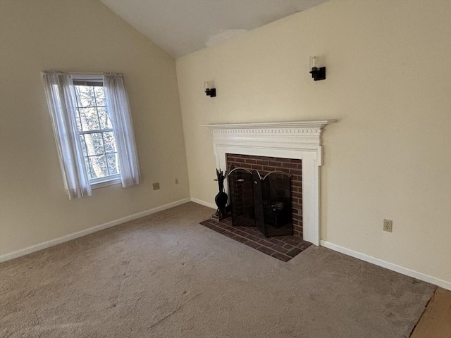 unfurnished living room with a fireplace, lofted ceiling, and dark colored carpet