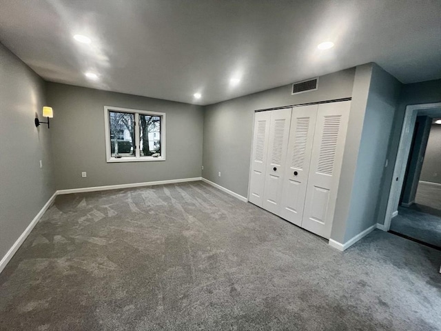 unfurnished bedroom featuring carpet flooring and a closet