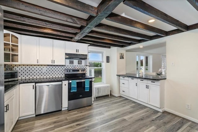701 Nashua Rd, Dracut, MA 01826 - kitchen with appliances with stainless steel finishes, radiator heating unit, dark countertops, backsplash, and light wood finished floors