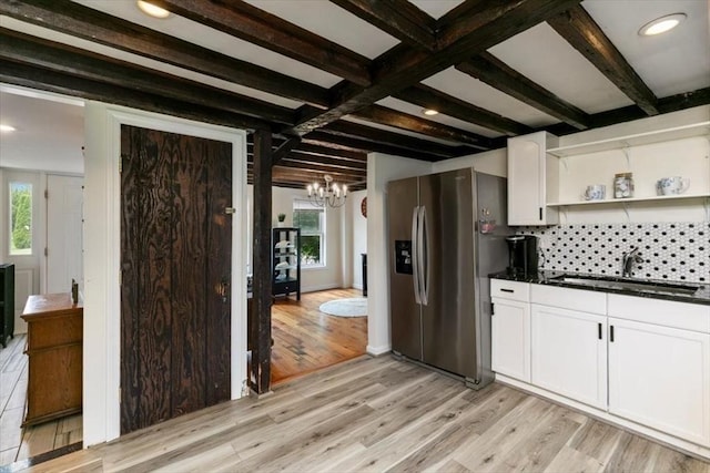 701 Nashua Rd, Dracut, MA 01826 - kitchen with stainless steel fridge, a sink, dark countertops, light wood-style flooring, and beam ceiling