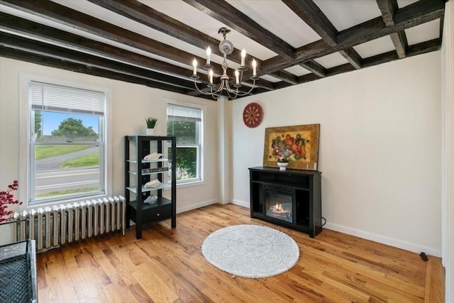 701 Nashua Rd, Dracut, MA 01826 - sitting room with radiator heating unit, a chandelier, beam ceiling, wood finished floors, and baseboards