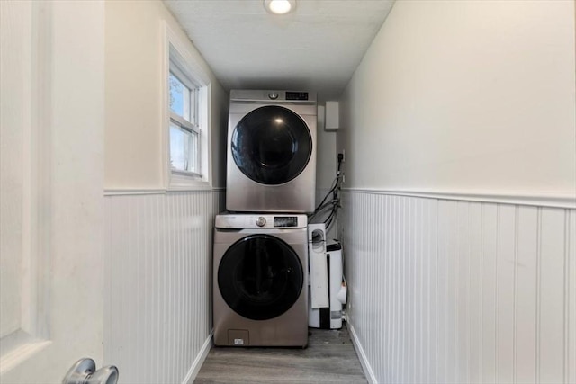 701 Nashua Rd, Dracut, MA 01826 - laundry room with stacked washer / dryer, wood finished floors, and a wainscoted wall