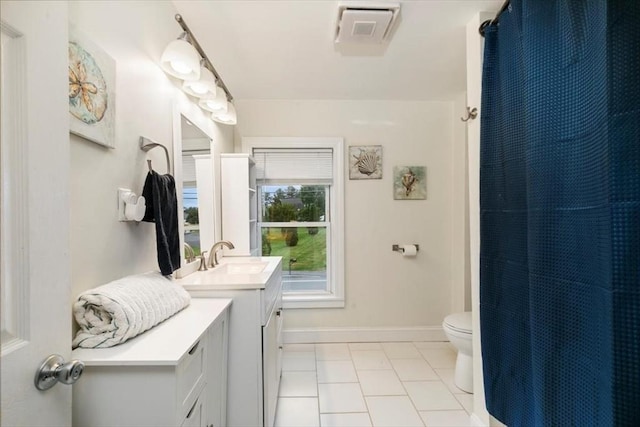 701 Nashua Rd, Dracut, MA 01826 - bathroom featuring vanity, toilet, tile patterned floors, baseboards, and a shower with shower curtain