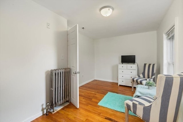 701 Nashua Rd, Dracut, MA 01826 - sitting room with radiator heating unit, wood finished floors, and baseboards