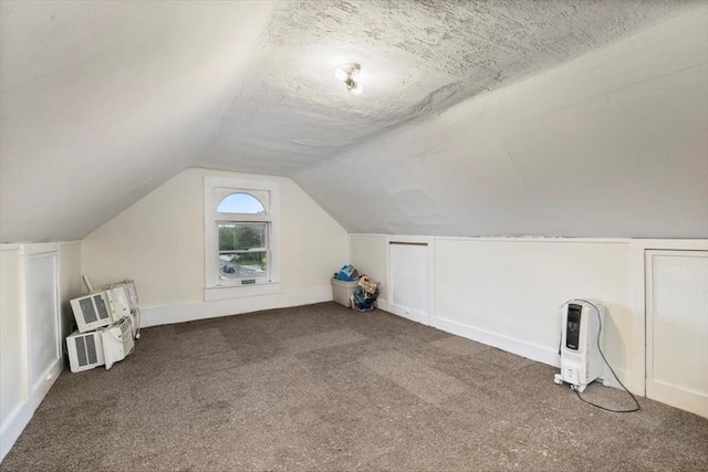 701 Nashua Rd, Dracut, MA 01826 - additional living space featuring carpet flooring, vaulted ceiling, and heating unit