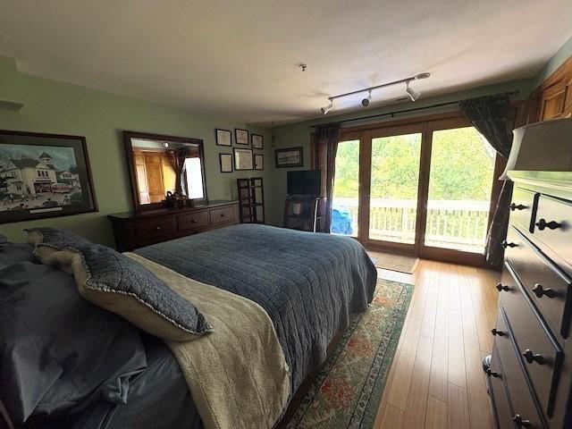66 Schooner Lndg Unit 66, Hampton, NH 03842 - bedroom featuring access to exterior and hardwood / wood-style flooring