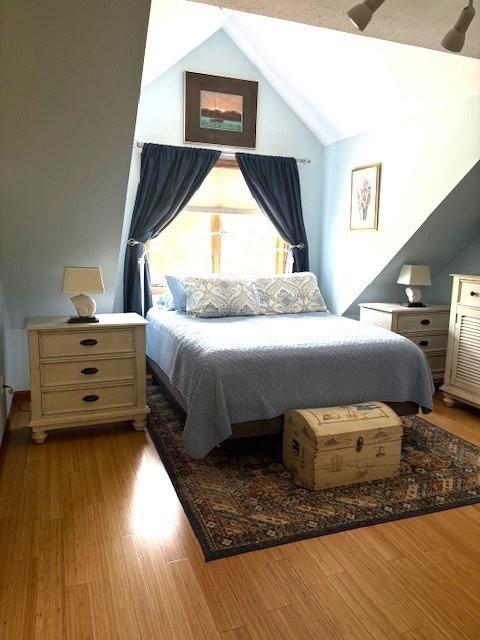 66 Schooner Lndg Unit 66, Hampton, NH 03842 - bedroom featuring lofted ceiling and wood finished floors