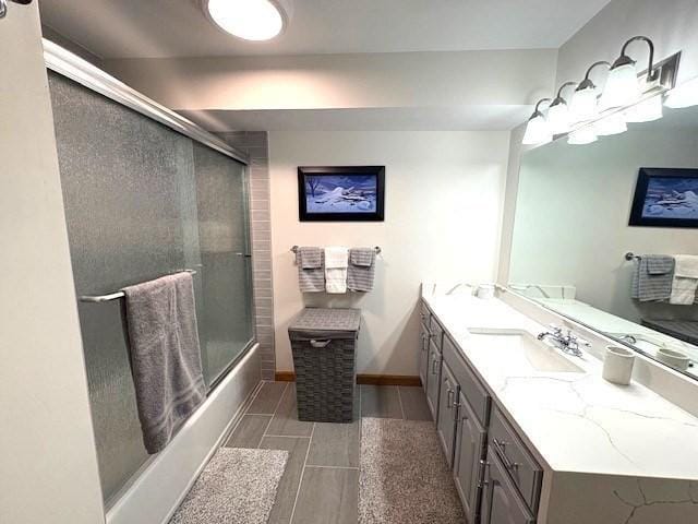 66 Schooner Lndg Unit 66, Hampton, NH 03842 - full bath featuring double vanity, shower / bath combination with glass door, and baseboards